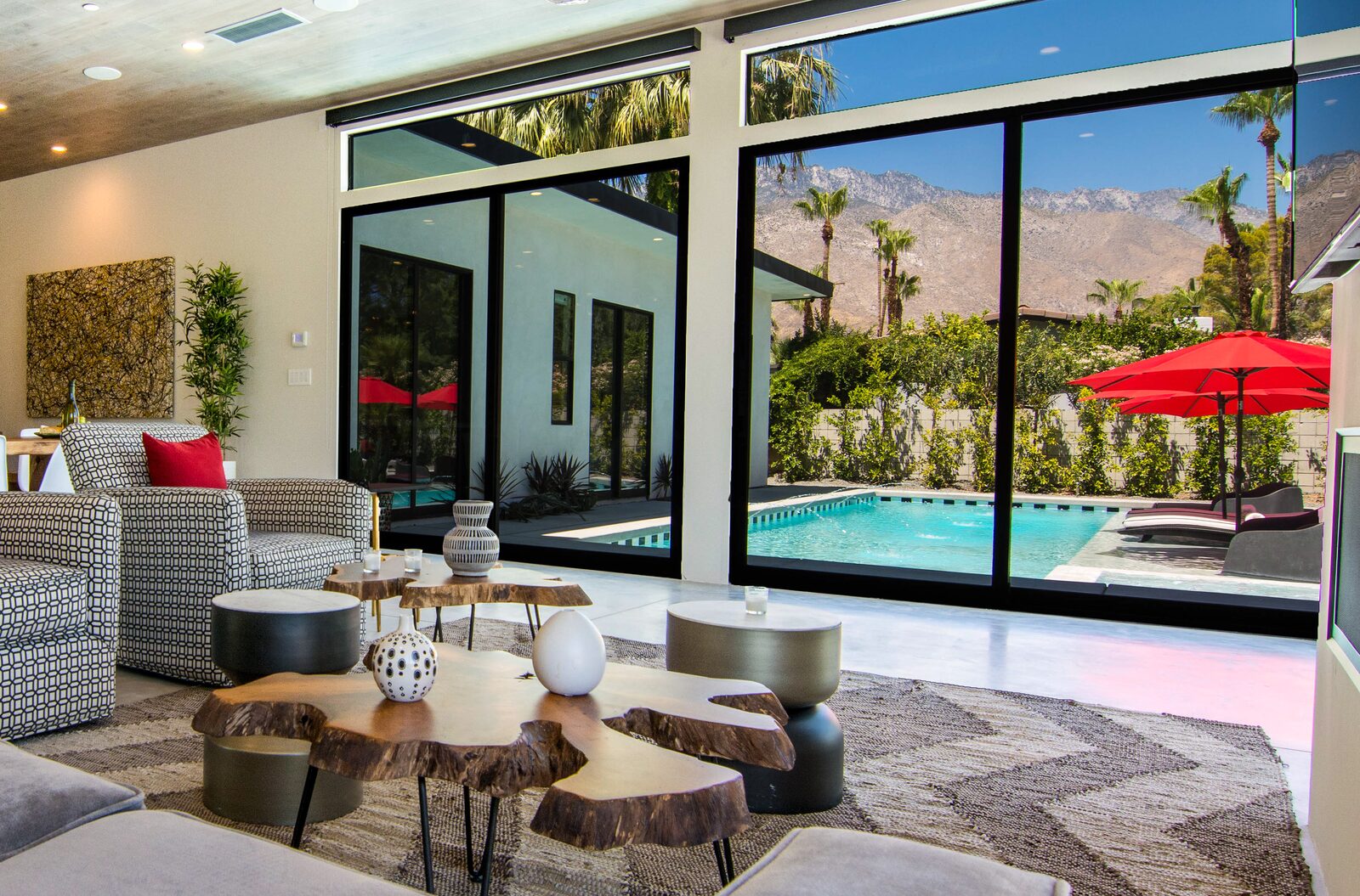 5 Palms Estate great room with red umbrella view through floor-to-ceiling glass