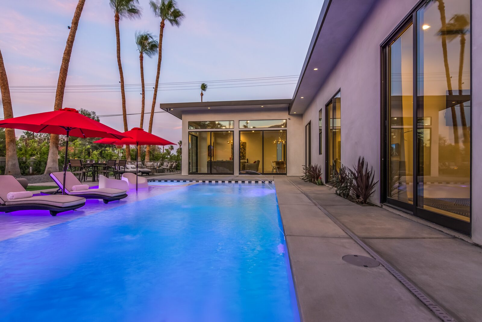 5 Palms Estate saltwater pool illuminated at dusk