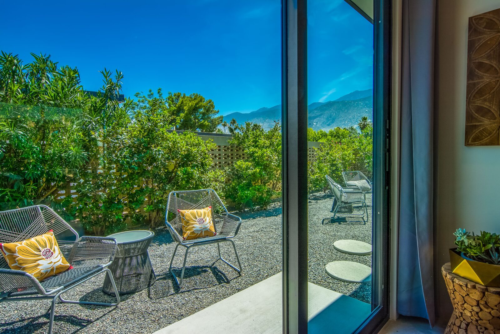 5 Palms Estate outdoor patio adjacent to a bedroom with wicker chairs