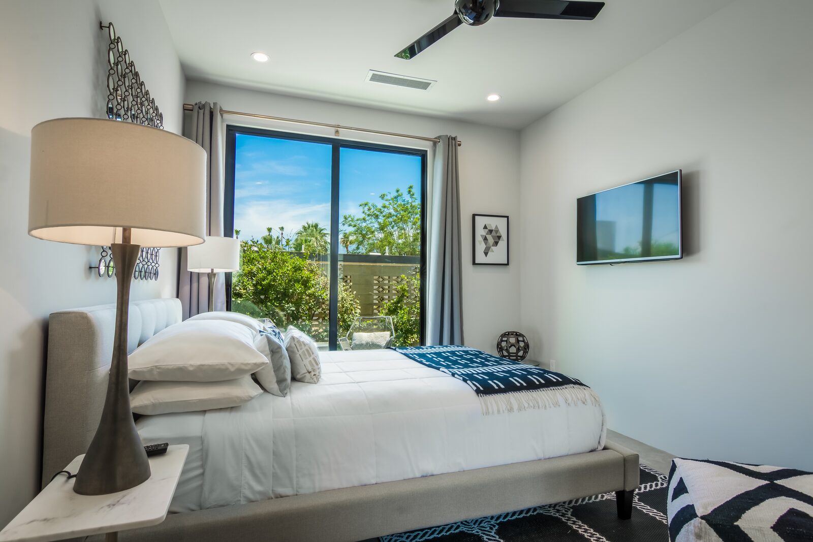 5 Palms Estate guest bedroom with sliding doors and pool view