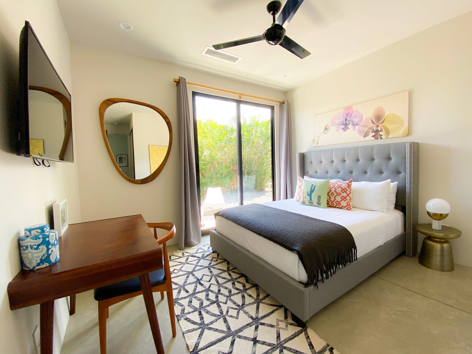 5 Palms Estate bedroom with warm accents and mounted mirror