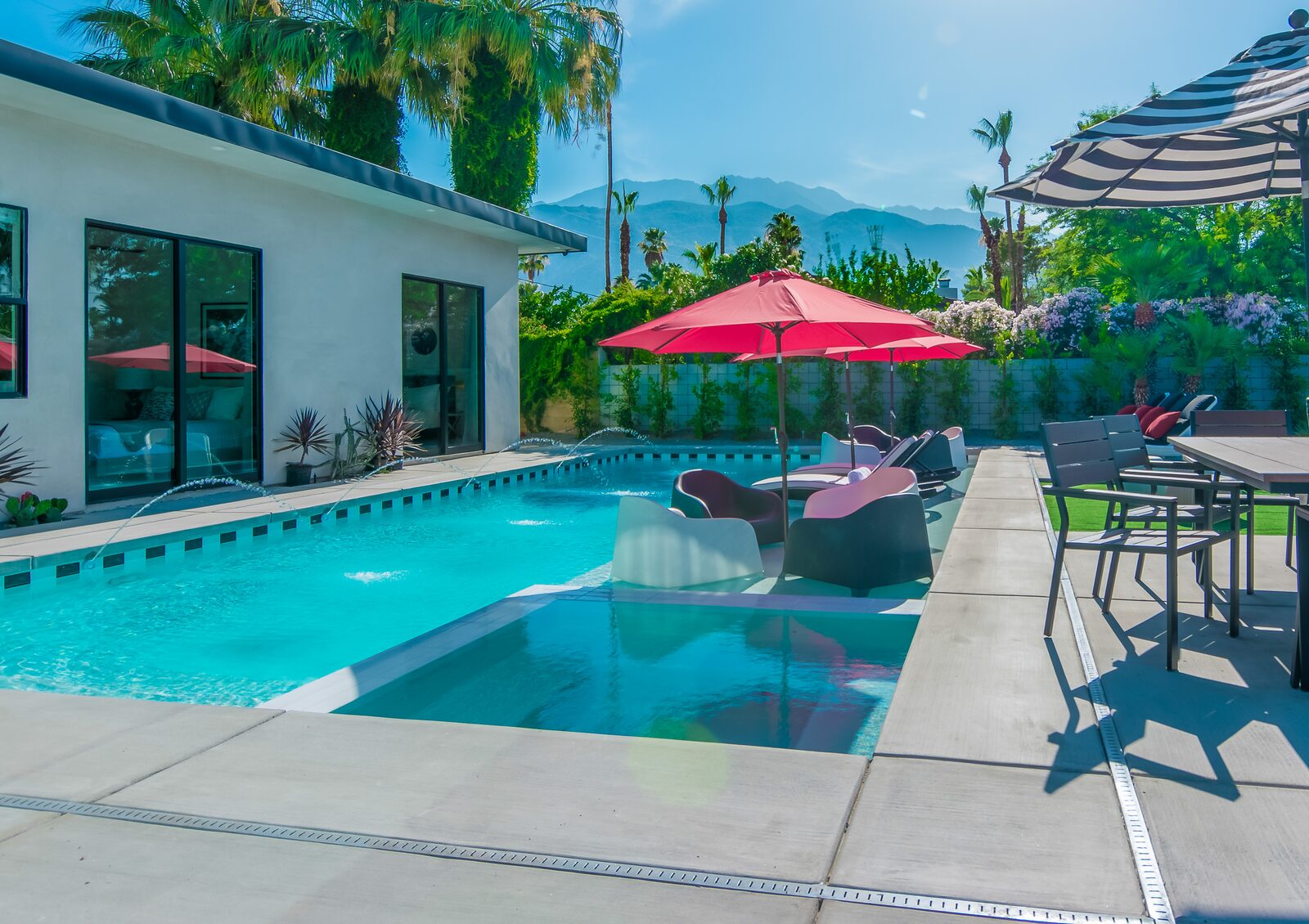 5 Palms Estate saltwater pool with red umbrellas and mountains