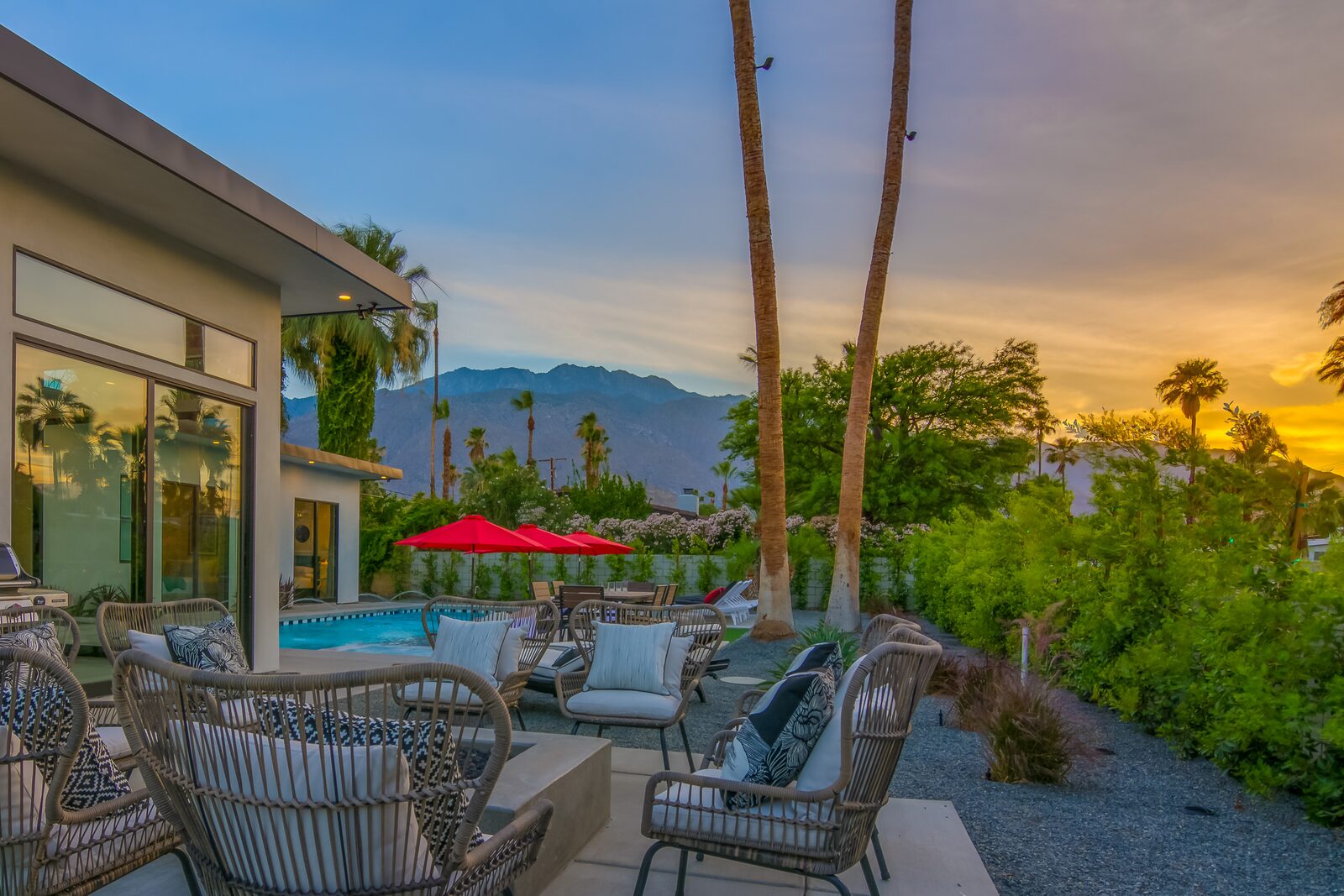 5 Palms Estate outdoor lounge at sunset with fire pit and palms
