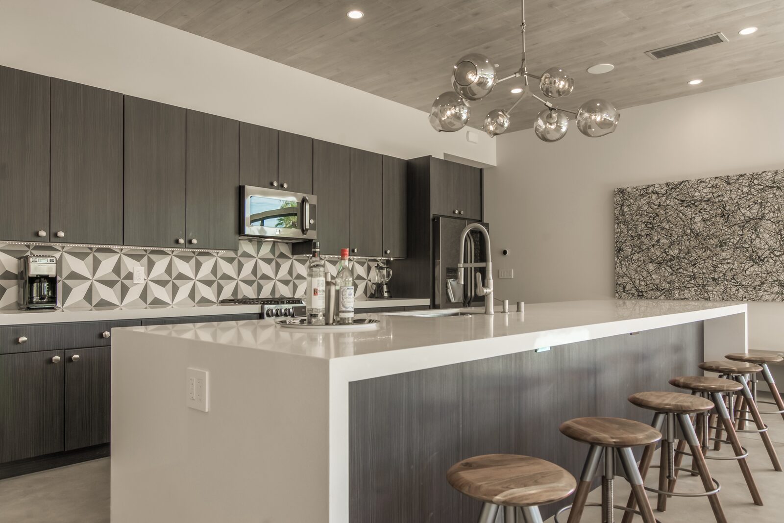 5 Palms Estate chef's kitchen with stainless appliances and stools