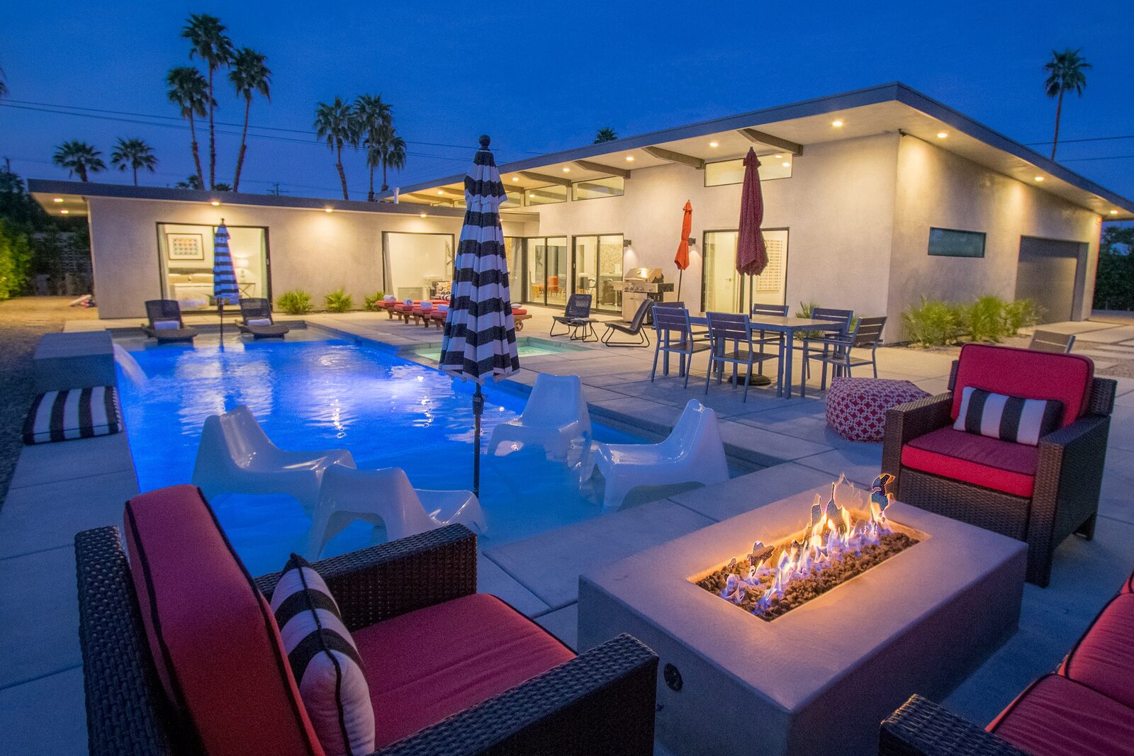 Palms at Park Villa outdoor fire pit and umbrellas at twilight