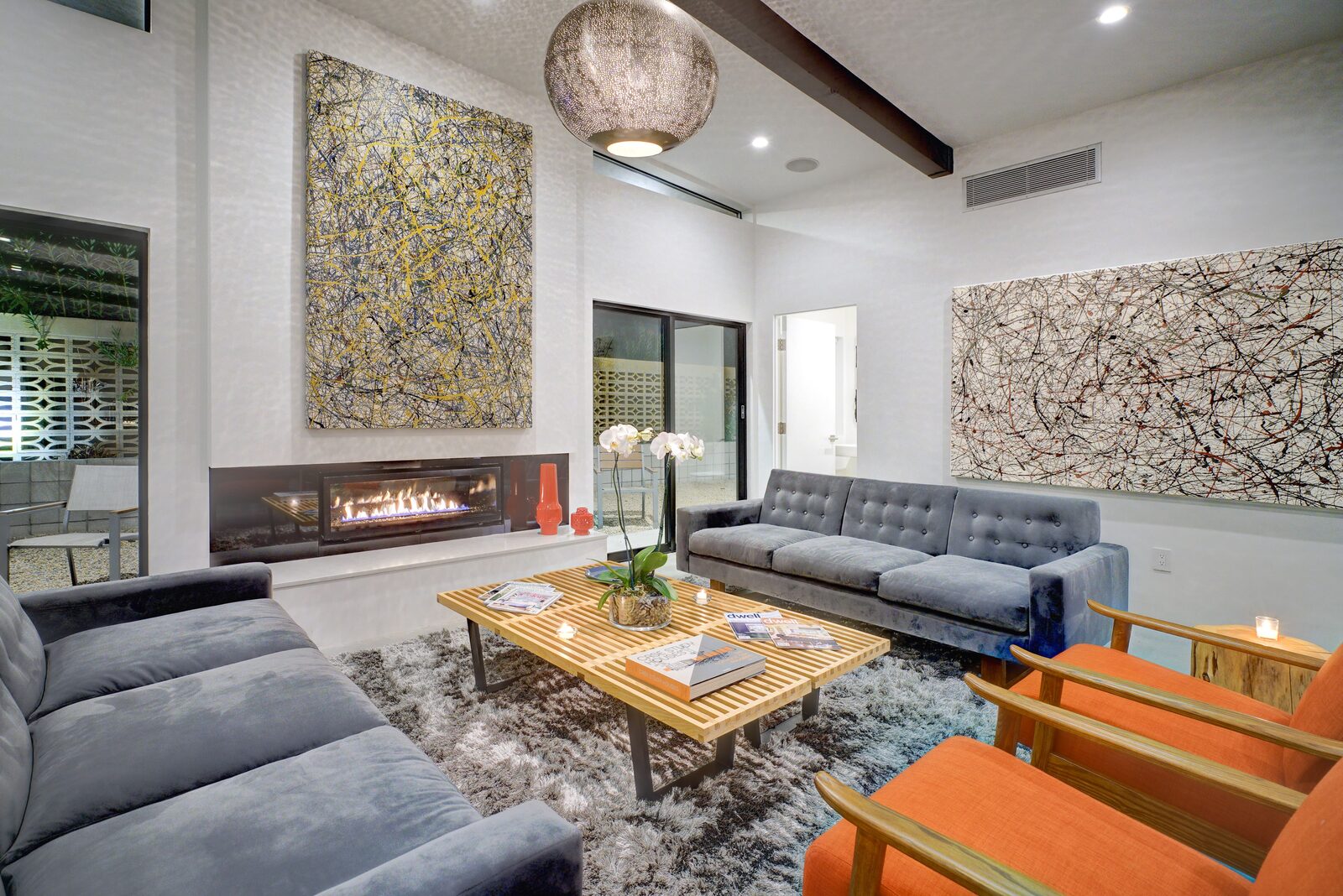 Palms at Park Villa living room with fireplace and design-forward art