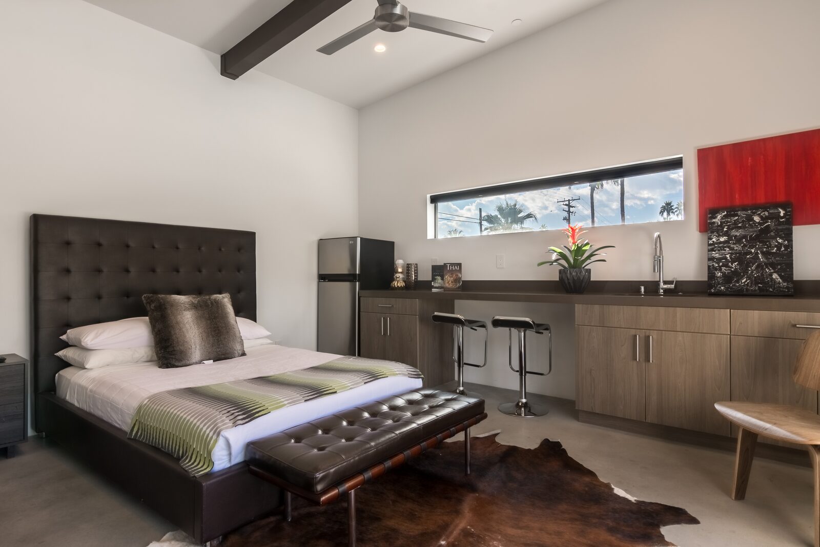 Palms at Park Villa bedroom with dark headboard and striped bedding