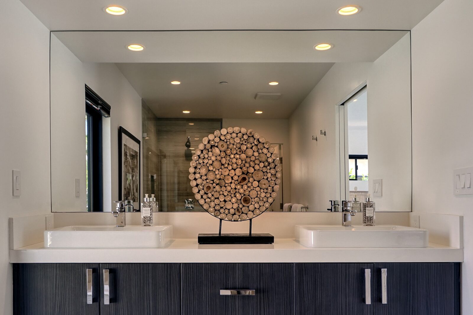 Palms at Park Villa primary bath vanity with sculptural accent